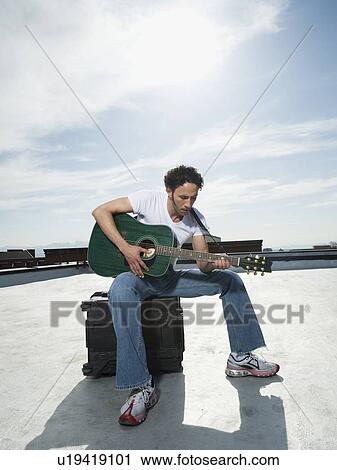 Stock Image - Man playing guitar. Fotosearch