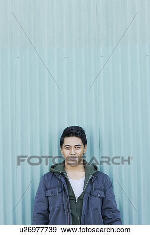 Stock Photo - Man posing against wall. Fotosearch