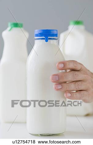 Stock Photo - Man reaching for milk bottle. Fotosearch