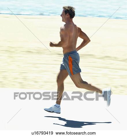 Man running on beach View Large Photo Image Stock Photo - Man running on beach. Fotosearch