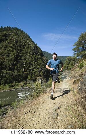 Man running on riverside trail View Large Photo Image Stock Image - Man running on riverside trail. Fotosearch