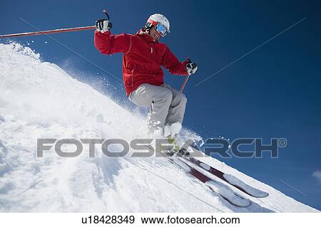 Man skiing downhill View Large Photo Image Stock Photo - Man skiing downhill. Fotosearch