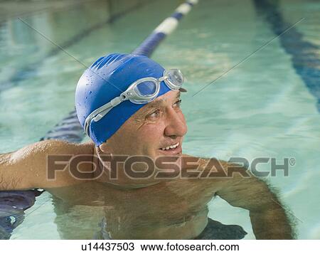 Stock Image - Man smiling in swimming pool. Fotosearch