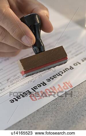 Man stamping “approved” on mortgage application View Large Photo Image Stock Image - Man stamping “approved” on mortgage application. Fotosearch