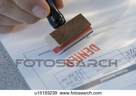 Man stamping “denied” on mortgage application View Large Photo Image Stock Photo - Man stamping “denied” on mortgage application. Fotosearch