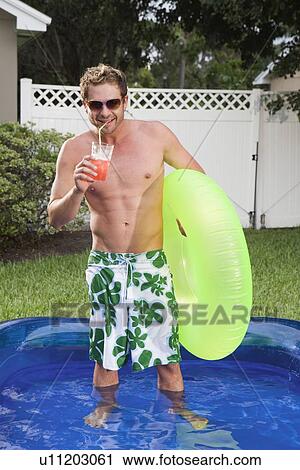 Man standing in inflatable swimming pool View Large Photo Image Stock Image - Man standing in inflatable swimming pool. Fotosearch