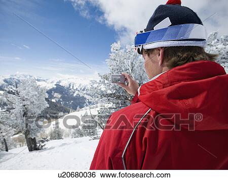 Stock Photograph - Man taking photograph, Wasatch Mountains, Utah, United States. Fotosearch