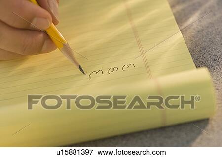 Stock Photo - Man writing “www” on legal pad. Fotosearch