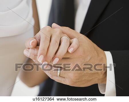 Picture - Married couple holding hands. Fotosearch