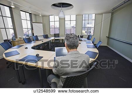 Mature businessman looking at laptop View Large Photo Image Stock Photo - Mature businessman looking at laptop. Fotosearch