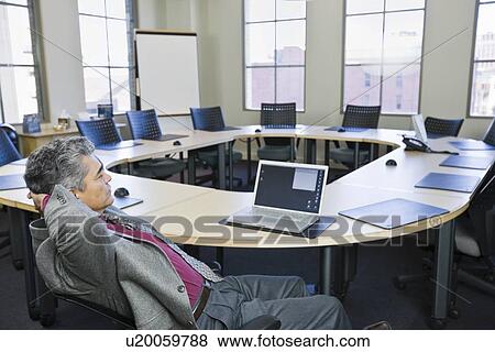 Mature businessman looking at laptop View Large Photo Image Stock Photo - Mature businessman looking at laptop. Fotosearch