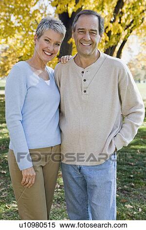 Stock Photography - Mature couple hugging outdoors. Fotosearch