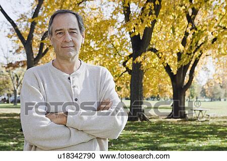 Stock Image - Mature man with arms crossed. Fotosearch