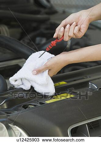 Mechanic checking oil View Large Photo Image Stock Image - Mechanic checking oil. Fotosearch