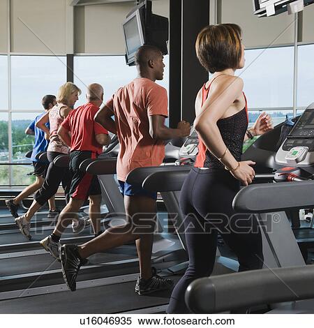 Men and women running on treadmills View Large Photo Image Stock Photography - Men and women running on treadmills. Fotosearch