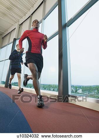 Men running on indoor track View Large Photo Image Stock Image - Men running on indoor track. Fotosearch