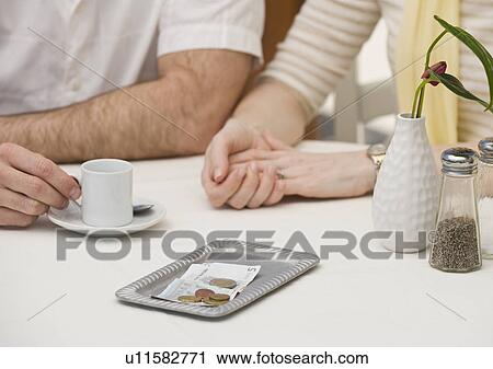 Money on restaurant table next to couple View Large Photo Image Stock Image - Money on restaurant table next to couple. Fotosearch
