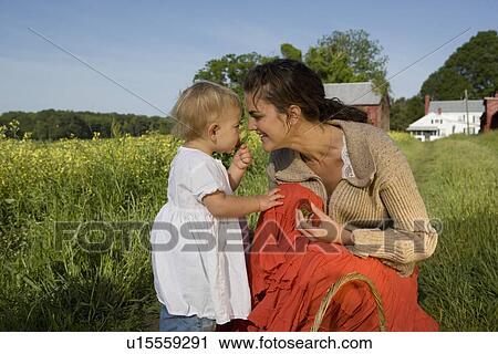 Mother and baby daughter picking strawberries View Large Photo Image Stock Image - Mother and baby daughter picking strawberries. Fotosearch