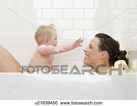 Stock Image - Mother and baby in bathtub. Fotosearch