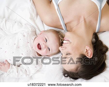 Mother and baby laughing View Large Photo Image Stock Image - Mother and baby laughing. Fotosearch