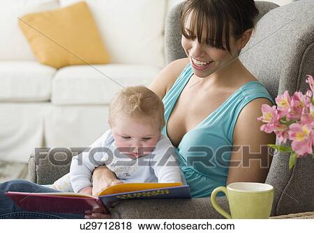 Mother and baby looking at book View Large Photo Image Stock Photo - Mother and baby looking at book. Fotosearch