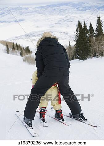 Stock Photograph - Mother and child skiing. Fotosearch