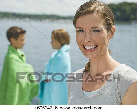Stock Photograph - Mother and children on dock. Fotosearch