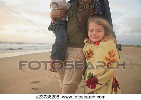 Mother and children walking on beach View Large Photo Image Stock Photo - Mother and children walking on beach. Fotosearch