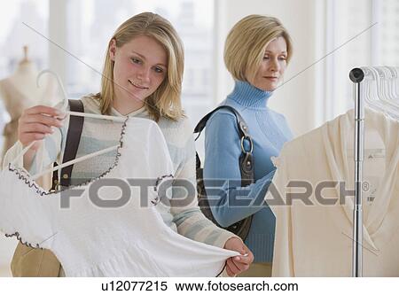 Stock Photography - Mother and daughter clothes shopping. Fotosearch