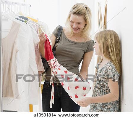 Picture - Mother and daughter clothing shopping. Fotosearch