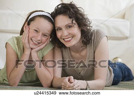 Stock Photo - Mother and daughter laying on floor. Fotosearch