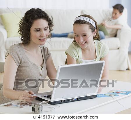 Mother and daughter looking at laptop View Large Photo Image Stock Photo - Mother and daughter looking at laptop. Fotosearch