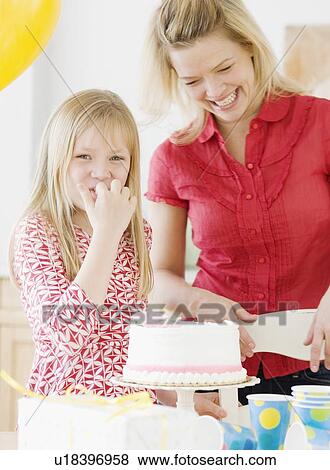 Mother and daughter next to birthday cake View Large Photo Image Stock Photo - Mother and daughter next to birthday cake. Fotosearch