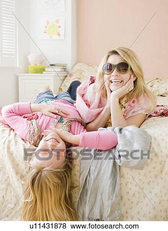 Stock Photo - Mother and daughter playing dress up. Fotosearch