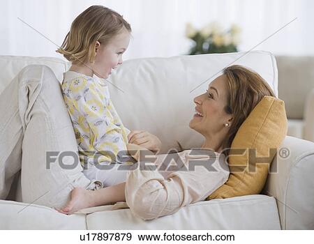 Stock Photo - Mother and daughter smiling at each other. Fotosearch