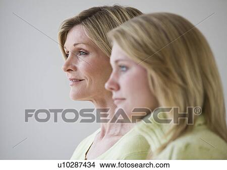 Mother and daughter standing next to each other View Large Photo Image Picture - Mother and daughter standing next to each other. Fotosearch