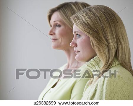 Mother and daughter standing next to each other View Large Photo Image Stock Photo - Mother and daughter standing next to each other. Fotosearch