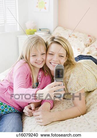 Mother and daughter taking own photograph View Large Photo Image Stock Image - Mother and daughter taking own photograph. Fotosearch