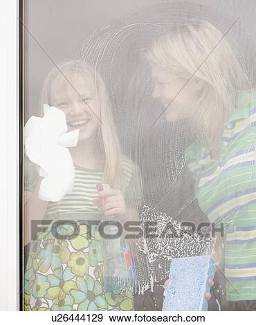 Mother and daughter washing window View Large Photo Image Stock Photo - Mother and daughter washing window. Fotosearch