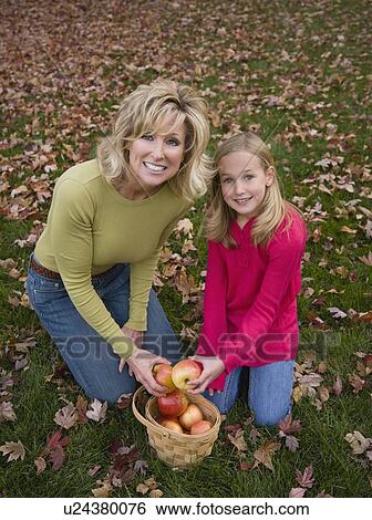 Mother and daughter with basket of apples View Large Photo Image Stock Photograph - Mother and daughter with basket of apples. Fotosearch
