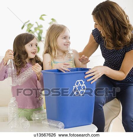 Mother and daughters filling recycling bin View Large Photo Image Stock Photograph - Mother and daughters filling recycling bin. Fotosearch
