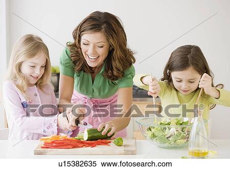 Mother and daughters preparing food View Large Photo Image Stock Photography - Mother and daughters preparing food. Fotosearch