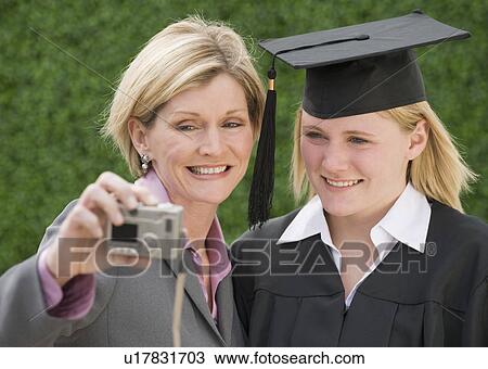 Mother and graduate daughter taking own photograph View Large Photo Image Stock Image - Mother and graduate daughter taking own photograph. Fotosearch