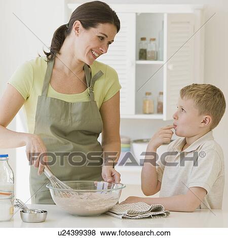 Stock Photo - Mother and son making batter. Fotosearch