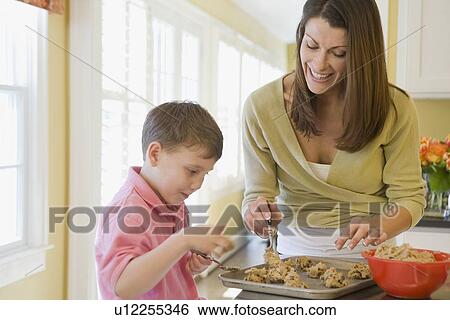 Stock Photograph - Mother and son making cookies. Fotosearch