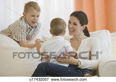 Mother and son smiling at baby View Large Photo Image Stock Photo - Mother and son smiling at baby. Fotosearch