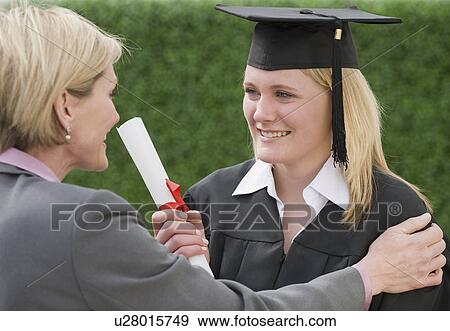 Stock Photo - Mother congratulating graduate daughter. Fotosearch