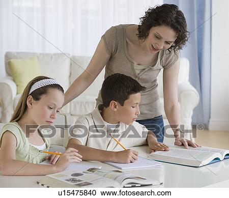 Mother helping children with homework View Large Photo Image Stock Image - Mother helping children with homework. Fotosearch