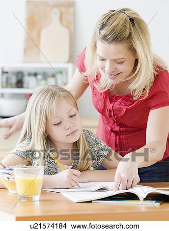 Picture - Mother helping daughter with homework. Fotosearch