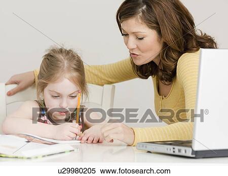 Mother helping daughter with homework View Large Photo Image Stock Photography - Mother helping daughter with homework. Fotosearch